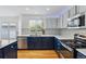 Modern kitchen showcasing white quartz counters, stainless appliances, and hardwood floors at 10517 Madison St, Thornton, CO 80233