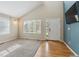 Bright living room with vaulted ceilings, large window, and a modern two-toned wall at 10517 Madison St, Thornton, CO 80233