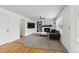 Cozy living room with a fireplace, built-in shelves, modern sofa, carpet, and hardwood floors at 10517 Madison St, Thornton, CO 80233