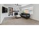 Bright living room featuring a fireplace, built-in shelves, modern sofa, and a large window at 10517 Madison St, Thornton, CO 80233