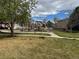Community playground with climbing structures and a slide, set among grass and trees at 10517 Madison St, Thornton, CO 80233