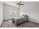 Comfortable bedroom offers a ceiling fan, neutral paint, and a bright window at 14447 Inca Ct, Westminster, CO 80023