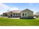 Rear exterior view of the home showcasing the well-manicured lawn and fenced-in yard at 14447 Inca Ct, Westminster, CO 80023