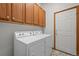 Functional laundry area with ample cabinet space and a convenient washer and dryer setup at 14447 Inca Ct, Westminster, CO 80023