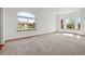 Bright living room with large windows offers plenty of natural light and a view of the neighborhood at 14447 Inca Ct, Westminster, CO 80023