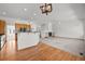 Open-concept living room boasts fireplace, ceiling fan, and wood floors near the kitchen at 14447 Inca Ct, Westminster, CO 80023