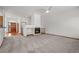 Open-concept living room featuring a fireplace and modern lighting, perfect for entertaining or relaxing at 14447 Inca Ct, Westminster, CO 80023