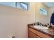Bathroom featuring stone countertop and a large mirror at 1199 Hummingbird Cir, Longmont, CO 80501