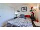 Bedroom featuring red accents, bedside table and slider closet door at 1199 Hummingbird Cir, Longmont, CO 80501