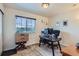 Bedroom with a large window offering outside views and an office setup at 1199 Hummingbird Cir, Longmont, CO 80501