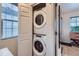 Hallway featuring closet laundry with stacked white washer and dryer at 1199 Hummingbird Cir, Longmont, CO 80501