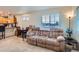 Comfortable living room featuring a large sofa and natural light from a large window at 1199 Hummingbird Cir, Longmont, CO 80501
