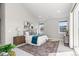 A bright bedroom features soft, neutral tones, a plush rug and lots of natural light at 2230 Rim Ridge Dr, Castle Pines, CO 80108