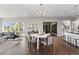 Open concept dining room with modern chandelier and view to living and kitchen areas at 2230 Rim Ridge Dr, Castle Pines, CO 80108