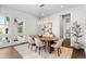 A dining room features modern lighting, lots of windows and bright, neutral finishes at 2230 Rim Ridge Dr, Castle Pines, CO 80108