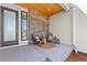 Inviting front porch featuring stylish seating and decorative stone accents at 2230 Rim Ridge Dr, Castle Pines, CO 80108