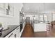 Modern kitchen featuring sleek white cabinets, stainless steel appliances, and dark countertops at 2230 Rim Ridge Dr, Castle Pines, CO 80108