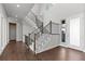 Elegant staircase with dark wood railing and plush carpet, leading to the upper level at 2230 Rim Ridge Dr, Castle Pines, CO 80108