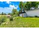 Backyard view featuring a storage shed and lush greenery on a sunny day at 3182 W Radcliff Dr, Englewood, CO 80110