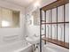 Tiled bathroom with a sink, toilet, bathtub with shower, and a window for natural light at 3182 W Radcliff Dr, Englewood, CO 80110