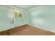 Bedroom with light green walls, wall trim, carpet and a window with decorative white curtains at 3182 W Radcliff Dr, Englewood, CO 80110