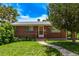 Charming brick home with a well-manicured lawn and inviting walkway at 3182 W Radcliff Dr, Englewood, CO 80110