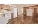 Spacious kitchen with wooden cabinets and natural light at 3182 W Radcliff Dr, Englewood, CO 80110