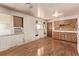 Eat in kitchen with wooden cabinets and adjacent living area at 3182 W Radcliff Dr, Englewood, CO 80110