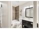 Bathroom with dark vanity, shower over tub, and neutral wall tile at 3260 Bit Rd, Evergreen, CO 80439