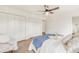 Bedroom with natural light, white folding closet doors, and hardwood floors at 3260 Bit Rd, Evergreen, CO 80439