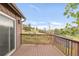 Spacious deck features wooden railings and plenty of sunlight overlooking a grassy hillside at 3260 Bit Rd, Evergreen, CO 80439