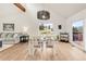 Open concept dining room with a slider leading to a deck, hardwood floors, and vaulted ceilings at 3260 Bit Rd, Evergreen, CO 80439