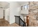 Entryway with stone wall accent, black banister, and natural light at 3260 Bit Rd, Evergreen, CO 80439