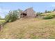 Two-story home featuring a stacked deck with wooden railings and a sloped lot at 3260 Bit Rd, Evergreen, CO 80439