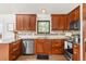 Well-lit kitchen with granite countertops, stainless steel appliances, and wood cabinets at 3260 Bit Rd, Evergreen, CO 80439