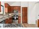 Updated kitchen with stainless appliances, granite counters, and wood cabinets at 3260 Bit Rd, Evergreen, CO 80439