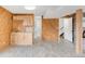 A kitchenette features cabinets and a sink, adjacent to a door and staircase at 3260 Bit Rd, Evergreen, CO 80439