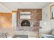 Bright living room featuring a brick fireplace and hearth, mantle, hearth and an art piece at 3260 Bit Rd, Evergreen, CO 80439