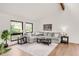 Bright living room featuring hardwood floors, natural light, and comfortable furniture at 3260 Bit Rd, Evergreen, CO 80439