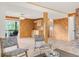 This open living room boasts a partial kitchen, wood paneled walls and sliding glass doors to a patio at 3260 Bit Rd, Evergreen, CO 80439