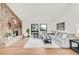 Living room with a stone fireplace, hardwood floors, natural light, and comfortable furniture at 3260 Bit Rd, Evergreen, CO 80439