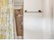 A shower features a light colored tile and a shower curtain with a floral pattern at 3260 Bit Rd, Evergreen, CO 80439