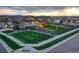 Aerial view of a home with a landscaped yard, including a pergola, playset, and green lawns at 7029 Sagerock St, Castle Pines, CO 80108
