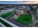 Fenced backyard features green lawn, playground, patio, and outdoor seating for relaxing and entertaining at 7029 Sagerock St, Castle Pines, CO 80108