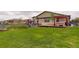 Large backyard with a playground, deck, pergola and green grass at 7029 Sagerock St, Castle Pines, CO 80108