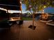 Evening backyard featuring a pergola swing, seating area, and a grassy lawn with a playset at 7029 Sagerock St, Castle Pines, CO 80108