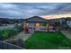 Spacious backyard with a deck, play set, and grassy area at 7029 Sagerock St, Castle Pines, CO 80108