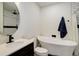 Modern bathroom with a sleek vanity, freestanding tub and rainfall shower head at 7029 Sagerock St, Castle Pines, CO 80108