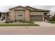 Charming home with a stone and siding exterior, two-car garage, and meticulously landscaped front yard at 7029 Sagerock St, Castle Pines, CO 80108