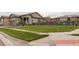 Well-maintained front yard with lush green lawn, tasteful landscaping and exterior of home in background at 7029 Sagerock St, Castle Pines, CO 80108